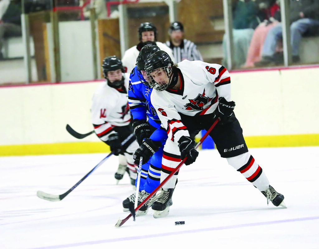 Courtesy Chaos Photography
Huron’s Ian Larson plays the puck during a game Saturday against Sioux Center at Bergman Arena. 