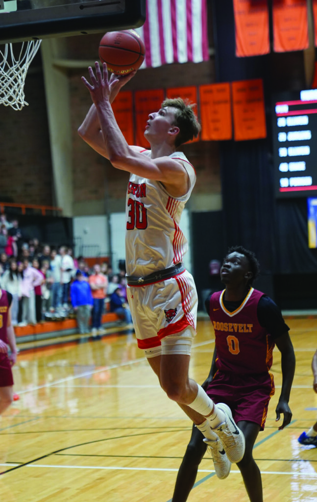 MIKE CARROLL/PLAINSMAN
Huron’s Blake Ellwein puts up a short jumper after getting past Sioux Falls Roosevelt’s Justin Bilal during their game Tuesday at Huron Arena.