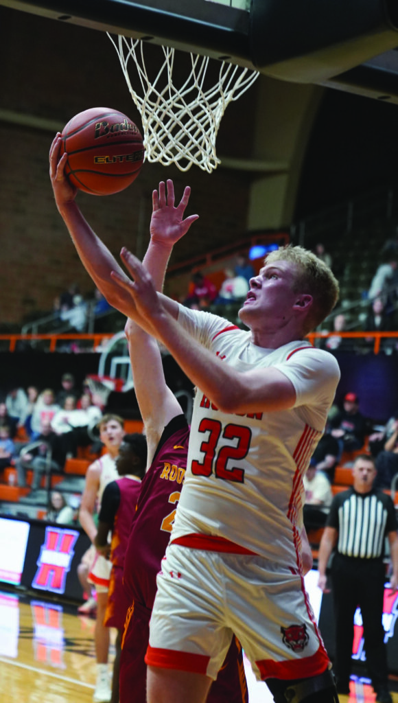 Huron’s Anderson Porisch puts up a reverse layup during a game against Sioux Falls Roosevelt on Tuesday at Huron Arena.
