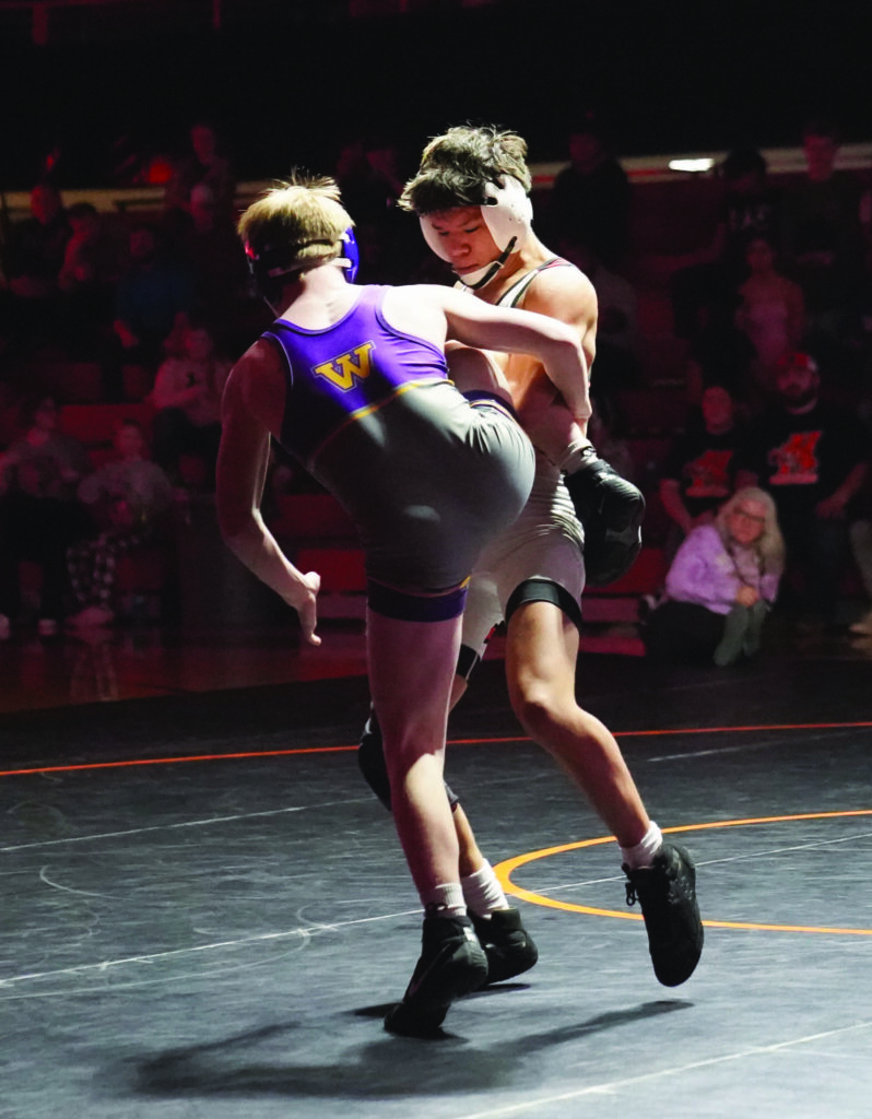 MIKE CARROLL/PLAINSMAN
Huron’s Ernest Wallette tries to takedown Tanner Urdahl of Watertown after getting in a single-leg during their 126-pound match Thursday at Huron Arena. 