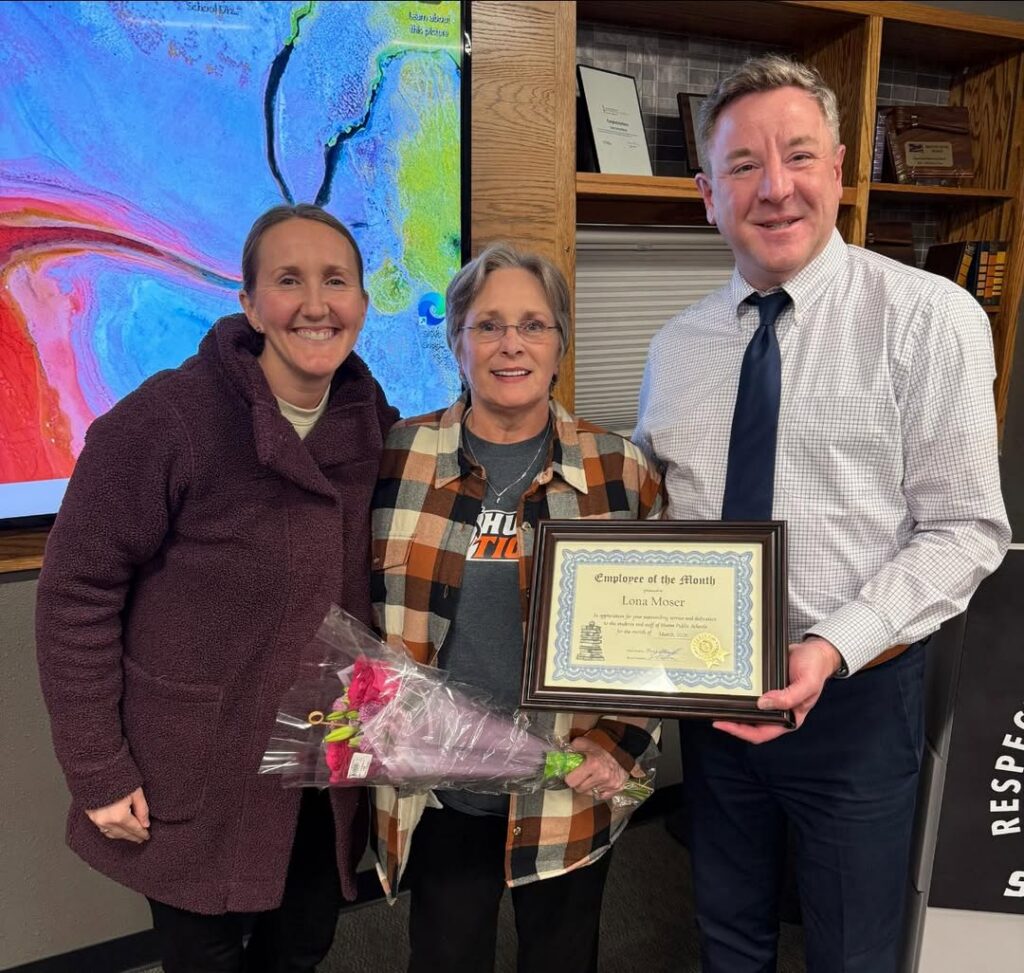 Courtesy Photo Lona Moser, center, para educator with the High School library, was recognized as the classified employee of the month for March. Presenting her award are Rachel Kary, left, and high school principal Rodney Mittlestadt.