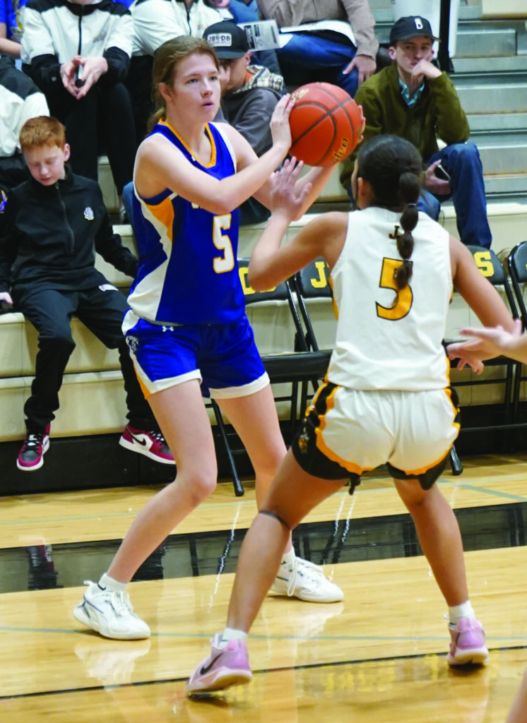 Mike Carroll/Plainsman
Masynn Mebius of Wessington Springs holds the ball on the perimeter as Dara Olowu-Davies of James Valley Christian defends during their game Friday at the JVC gym.