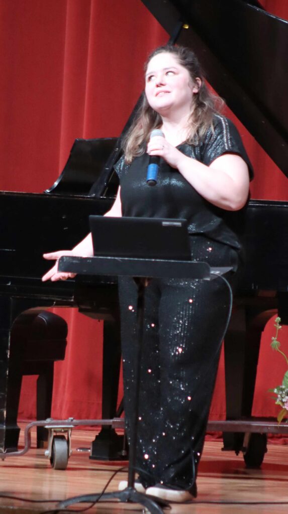 Benjamin Chase/Plainsman
Tabitha Unruh explaining the fundraising efforts for the piano to open the recital.