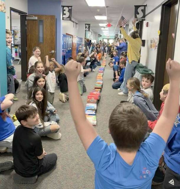 Elementary students and staff cheered with excitement when all of the cereal boxes toppled over like dominoes!