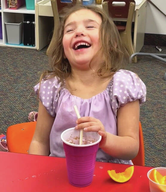 Preschooler Emerson Zutter gets the giggles after blowing bubbles in her root beer float.
