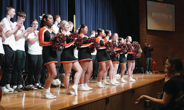 The Tiger cheerleaders lead the crowd in the school song. Mike Carroll/Plainsman