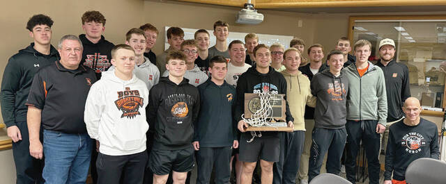 Members of the Huron Tigers boys basketball team and coaches pose with Huron Mayor Mark Robish after being recognized during Mondays Huron City Commission meeting.
                                 Benjamin Chase/Plainsman