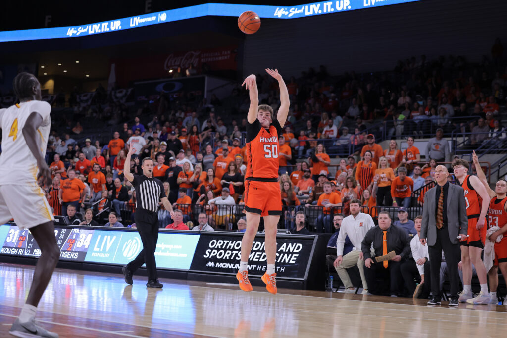 Photo courtesy SDPB Carter Porisch hits a big three in front of the Huron bench late in Friday's win over Sioux Falls Roosevelt at the Class AA State Tourney in Rapid City.