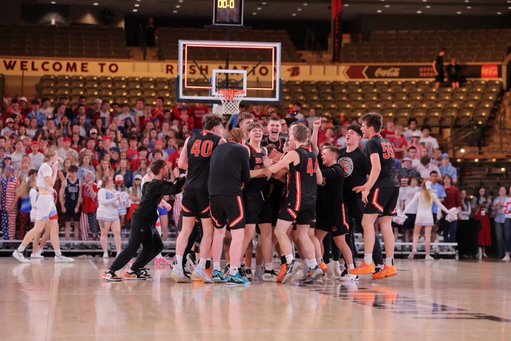 Photo courtesy SDPB The Huron Tigers team celebrates after winning the 2026 Class AA State Championship Saturday in Rapid City with a 59-47 victory over Sioux Falls Lincoln.