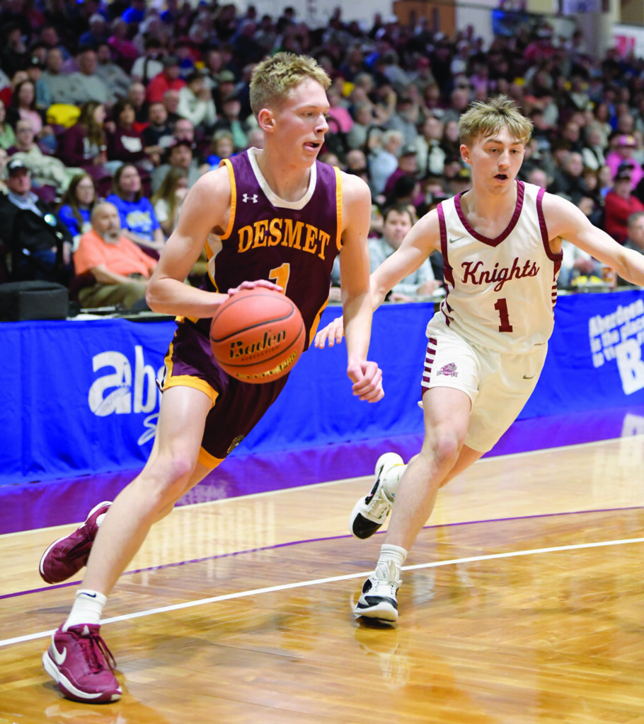 De Smet’s Noah Luethmers dribbles past Aberdeen Christian’s Dylan Hofer during the consolation championship game of the Class B State Tournament on Saturday at the Barnett Center in Aberdeen. (photo courtesy of SDPB)
