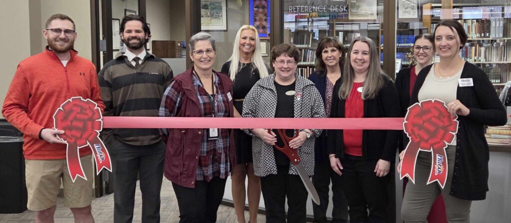 Courtesy Photo Library staff and Chamber Ambassadors celebrate the ribbon-cutting on Tuesday.