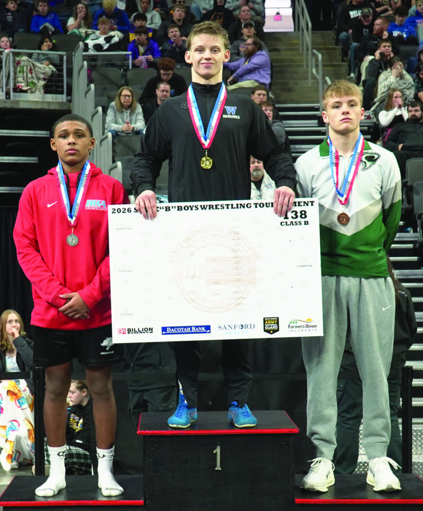 SOUTH DAKOTA PUBLIC BROADCASTING
Jacksen Carter of Wessington Springs/Woonsocket/Wolsey-Wessington stands on top the podium after winning the 138-pound title at the Class B State Tournament on Saturday at the Denny Sanford Premier Center in Sioux Falls.