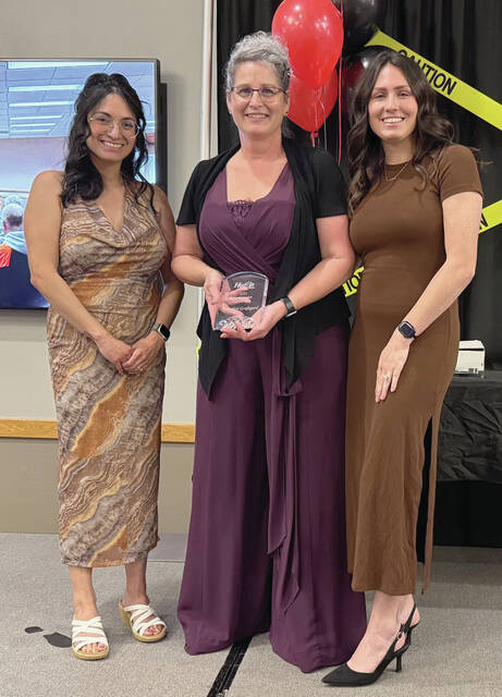 Benjamin Chase/Plainsman Marilyn Grafsgard, center, receives the Ambassador of the Year award from Chamber member services director Mitzi Mandel, left, and Chamber President/CEO Brianna Johnson, right.