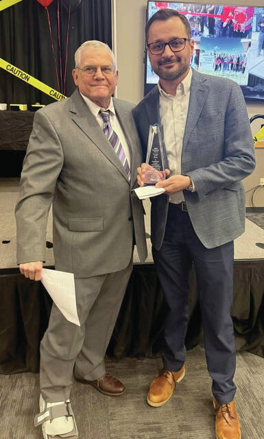 Courtesy Photo Levi Kary, right, receives the Rising Star Award from Dr. Robert Hohm.