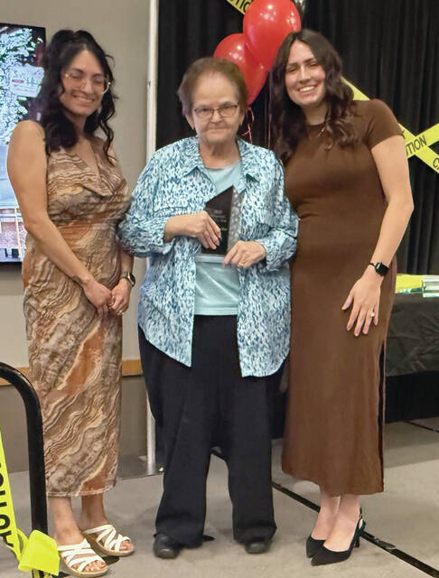 Benjamin Chase/Plainsman Carol Huether, center, is awarded the Volunteer of the Year.