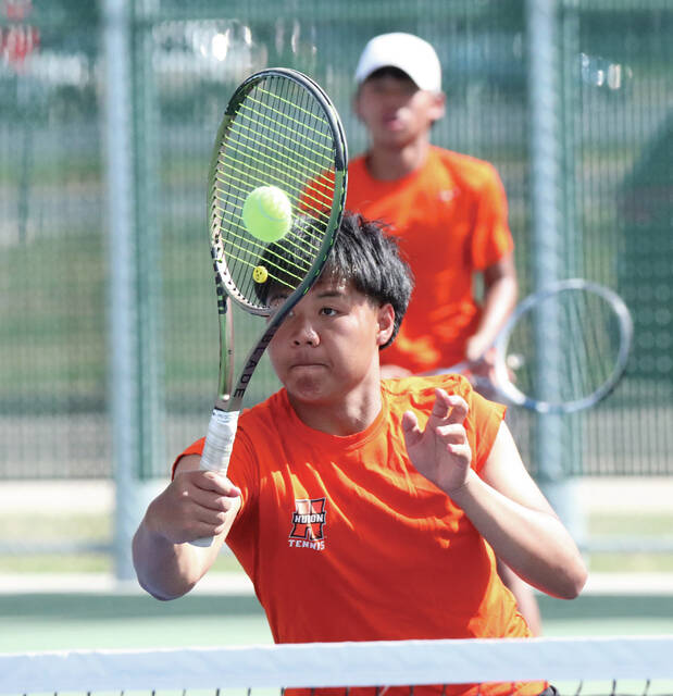 Photo courtesy Joel Bergeson Hurons Klee Htoo plays a shot at the net during a No. 1 doubles match on Thursday at Huron Courts.