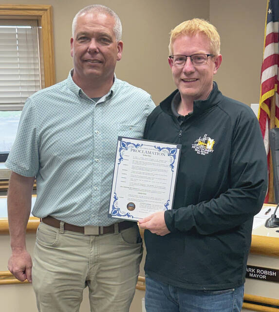 Benjamin Chase/Plainsman Parks & Recreation Director Chad Schroder receives a proclamation recognizing Arbor Day from Huron City Commissioner Shawn Harvey at Mondays city commission meeting.