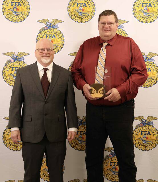 Courtesy Photo De Smet FFA advisor Dave VanderWal, right, accepts the Golden Owl Agricultural Educator of the Year award.