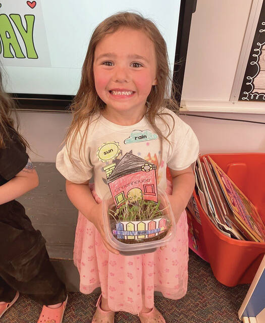 Preschooler Emerson Zutter is excited to share her house that she designed and to see all the grass growing.