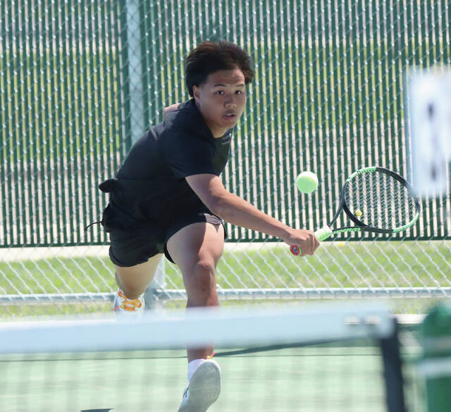 COURTESY OF JOEL BERGESON Hurons Klee Htoo plays a shot during a match against Aberdeen Roncalli on Friday at Huron Courts.