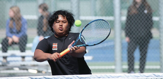 COURTESY OF JOEL BERGESON Hurons Ywa Hae Moo plays a shot at the net during a No. 2 doubles match against Aberdeen Roncalli on Friday at Huron Courts.