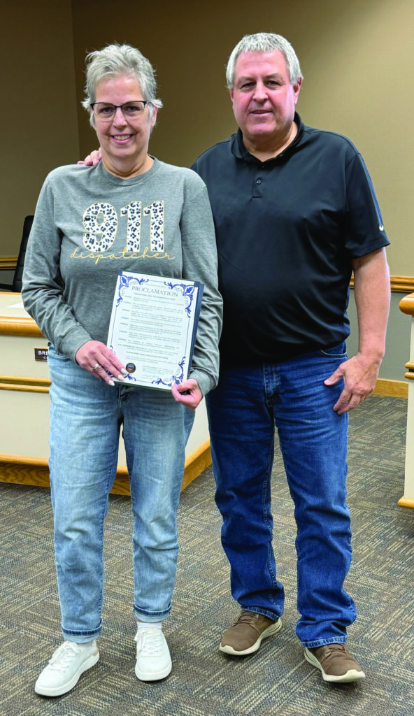Benjamin Chase/Plainsman 911 telecommunicator Gina Small, left, accepts the proclamation on National Public Safety Telecommunicators Week from Mayor Mark Robish.
