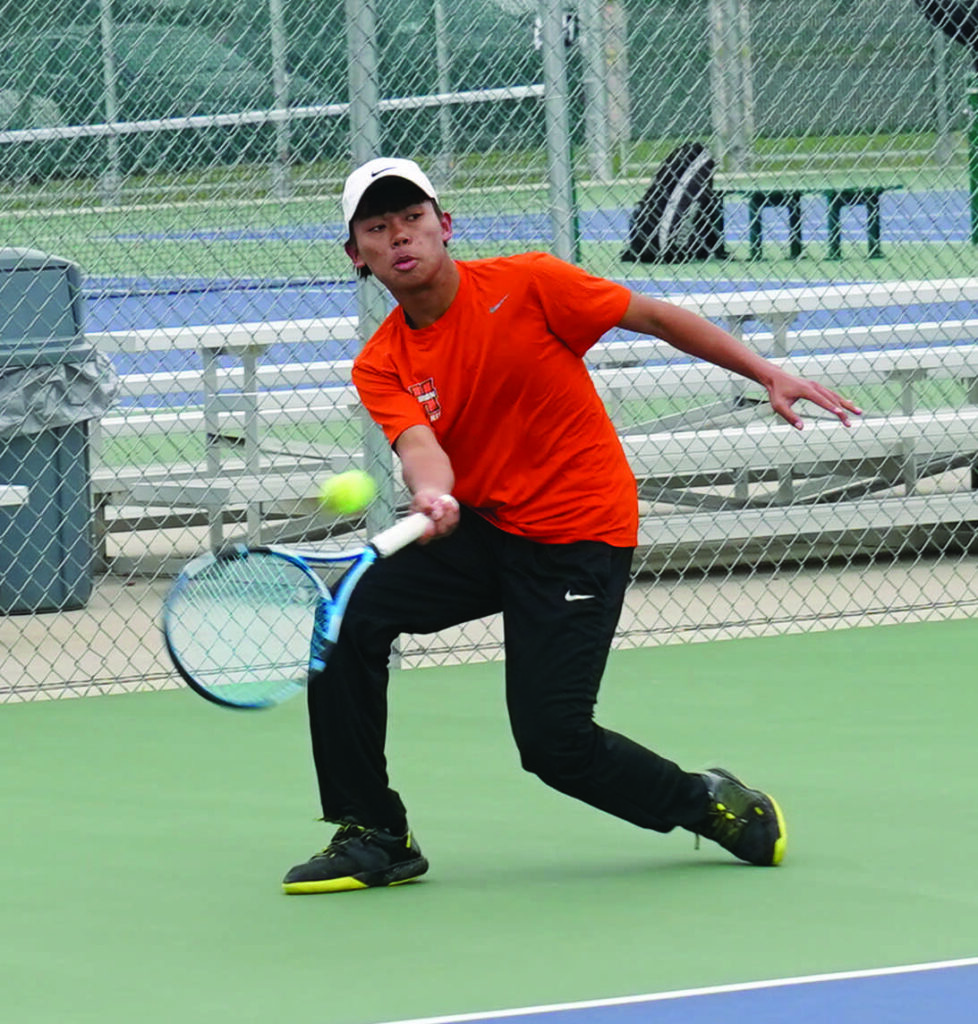 MIKE CARROLL/PLAINSMAN Huron’s Htoo Zan returns the ball during a No. 1 singles match against Watertown on Saturday at Huron Courts.