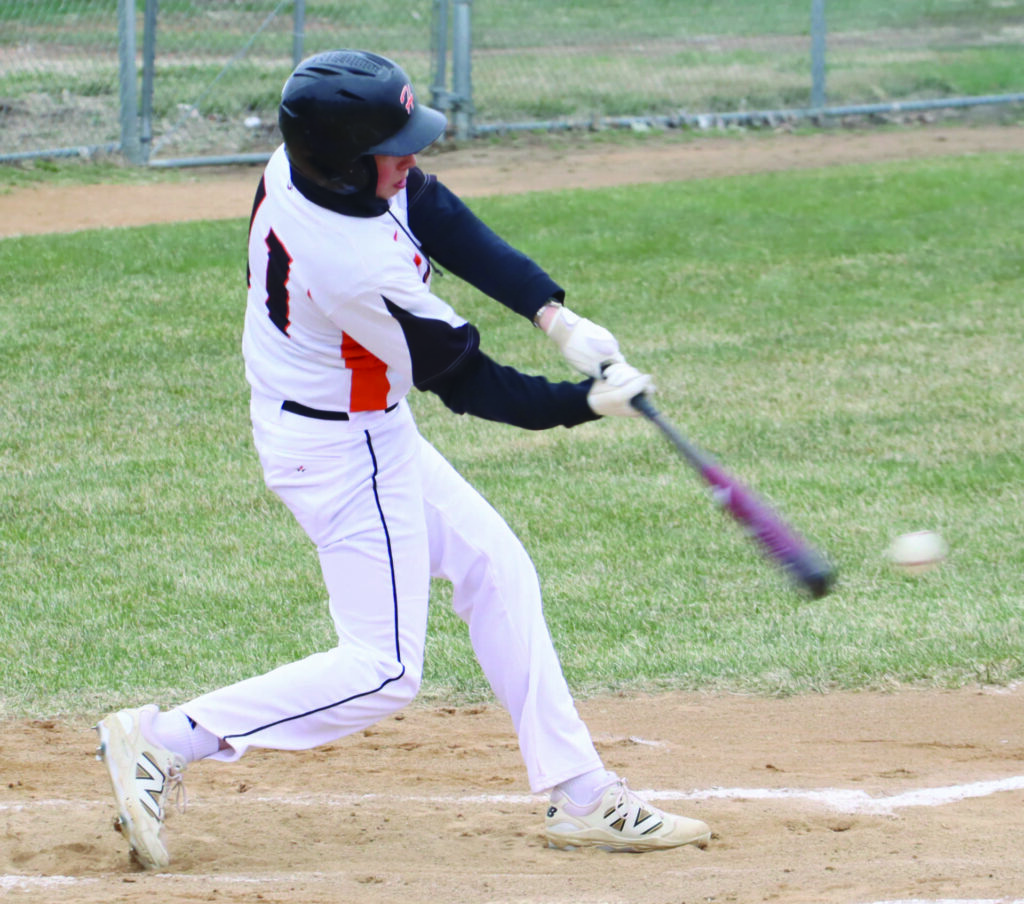 Benjamin Chase/Plainsman Huron’s Sean Janes connects on a run-scoring double during the first game of Saturday’s junior varsity doubleheader against Sioux Falls Lincoln at Klock Field.