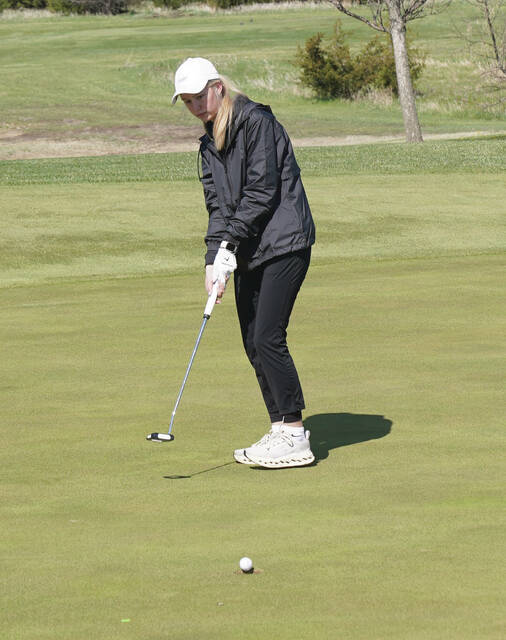 MIKE CARROLL/PLAINSMAN Allison Westendorf of Sanborn Central/Woonsocket watches her ball fall in the hole during a putt Thursday in the 281 Conference Golf Tournament at Broadland Creek Golf Course.