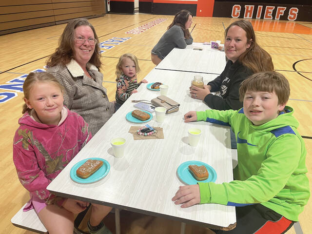 Iroquois second grader Emma Dorris and her brother, fourth grader Christopher Dorris enjoyed spending time with their little sister, mom and grandma while enjoying a long john donut.