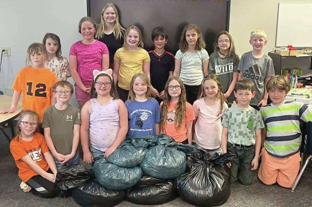 Courtesy Photo Iroquois FCCLA member Madi Burma poses with the third grade class, winners of the elementary pop tab war.