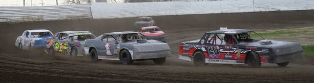 MIKE CARROLL/PLAINSMAN Jayden Bogh of Huron leads Cliff Houser of KImball, Chris Serr of Aberdeen and Wyatt Brooker of Tulare during their WISSOTA street stock heat race on Saturday at Dakota State Fair Speedway.