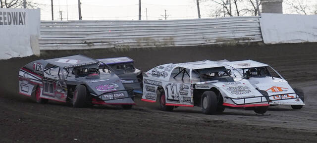 Mike Carroll/Plainsman Darren Engesser of Gary, left, Adam Brotherton of Huron, center, and Nick Perry of Huron battle for the lead during their WISSOTA Midwest modified heat race on Saturday at DSFS.