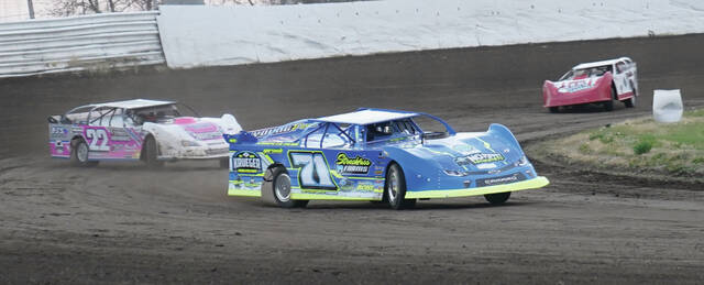 MIKE CARROLL/PLAINSMAN Trevor Nelson of Warner leads Bryson North of Huron during their WISSOTA super stock heat race on Saturday at Dakota State Fair Speedway.