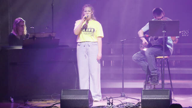 Ellie Bragg sings A Thousand Years accompanied by Charlie Bragg on guitar and Dr. Beth Neitzert on piano.
                                 Benjamin Chase/Plainsman