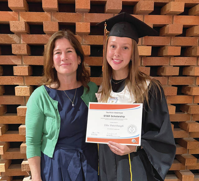 P.E.O. member Sarah Rubish, left, presents the STAR scholarship to Ellie Puterbaugh.