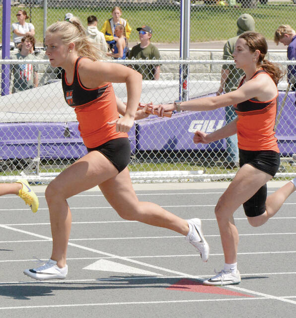Hurons Olivia Tschetter hands the baton to teammate Jayla Schley during the girls 400-meter rlelay at the Eastern South Dakota Conference Meet on Saturday in Watertown.
Photo courtesy Roger Merriam/Watertown PO