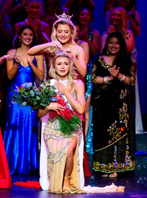 Photo by Bob Grandpre/Grandpre Photography Huron native Jamee Kattner places the crown on 2026 Miss South Dakota Kianna Healy Saturday in Brookings.