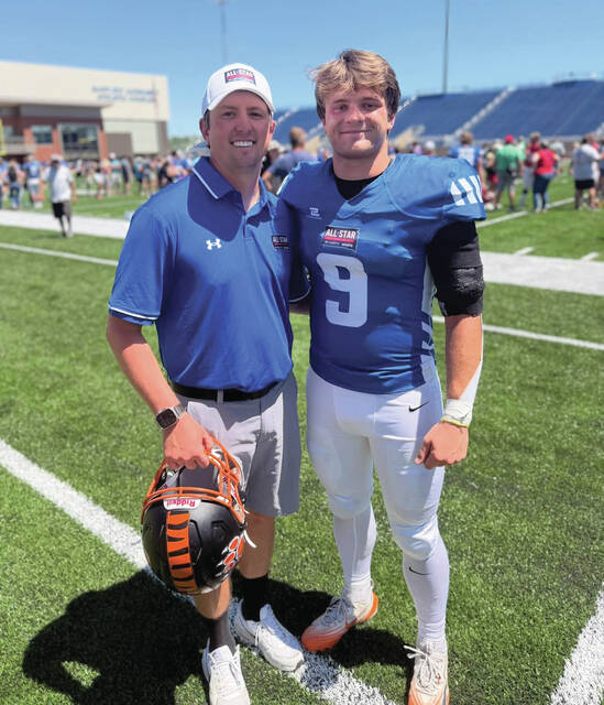 Huron High School graduate Landon Hulst is joined by coach Dru Strand during the South Dakota Football Coaches Associations 2026 High School Senior Bowl on Saturday at South Dakota States Dana J. Dykhouse Stadium.